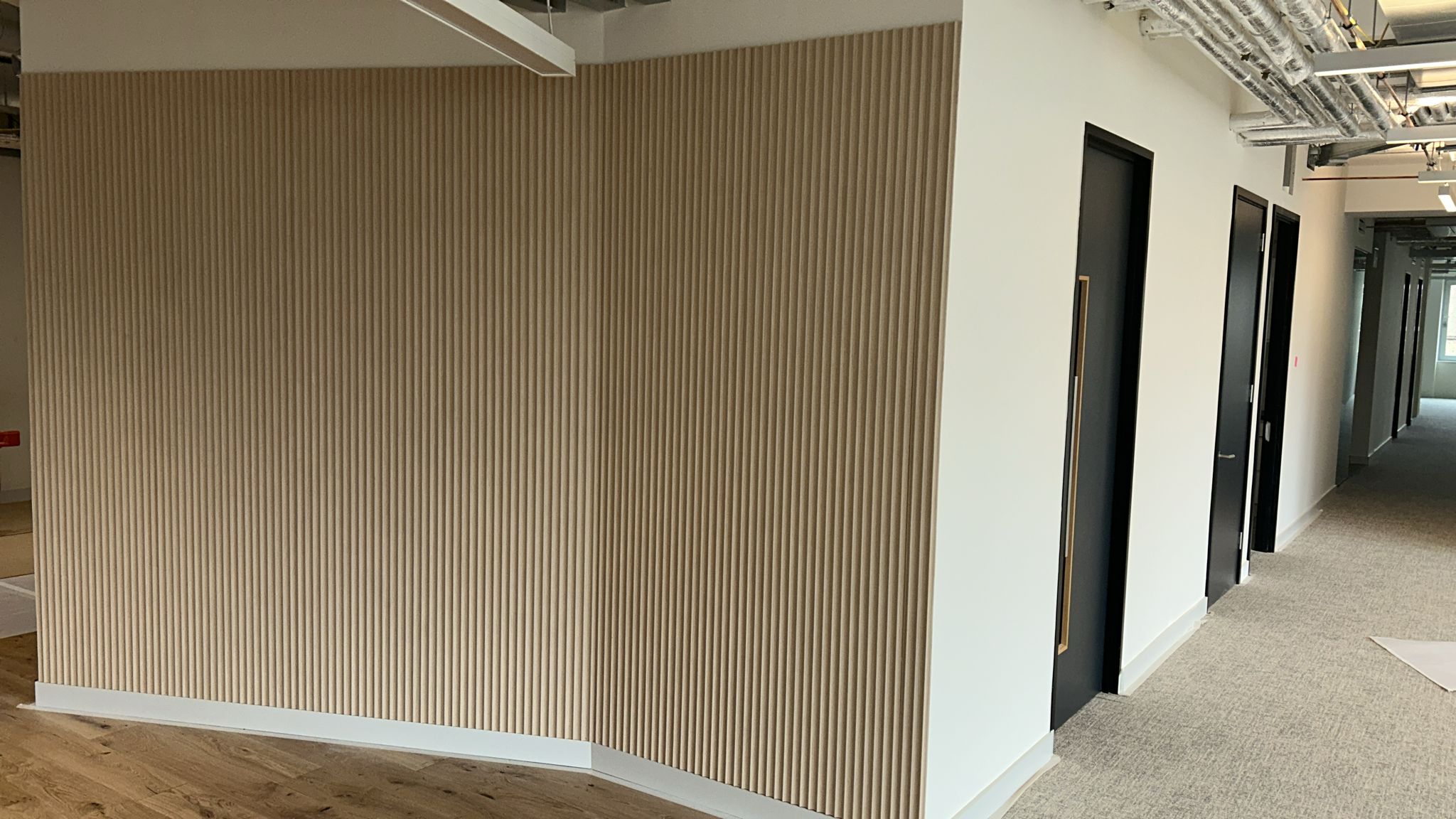 Oliver's Yard — Naturewall oak fluted feature wall with black laminate doors